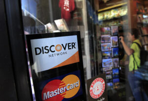 (Mandatory Credit: Photo by Steven Senne/AP/REX/Shutterstock (6224484a) A Discover logo is adhered to a window at the entrance of a shop in Cambridge, Mass. Discover Financial Services on Thursday, Dec. 20, 2012 reported higher earnings for its fiscal fourth quarter, as users of its namesake credit card stepped up purchases and the company wrote off fewer unpaid balances Earns-Discover Financial, Cambridge, USA)