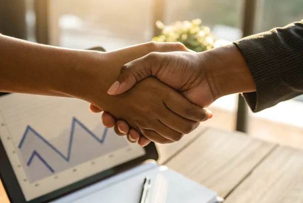 A business owner finalizing an agreement with one of the best merchant account providers.